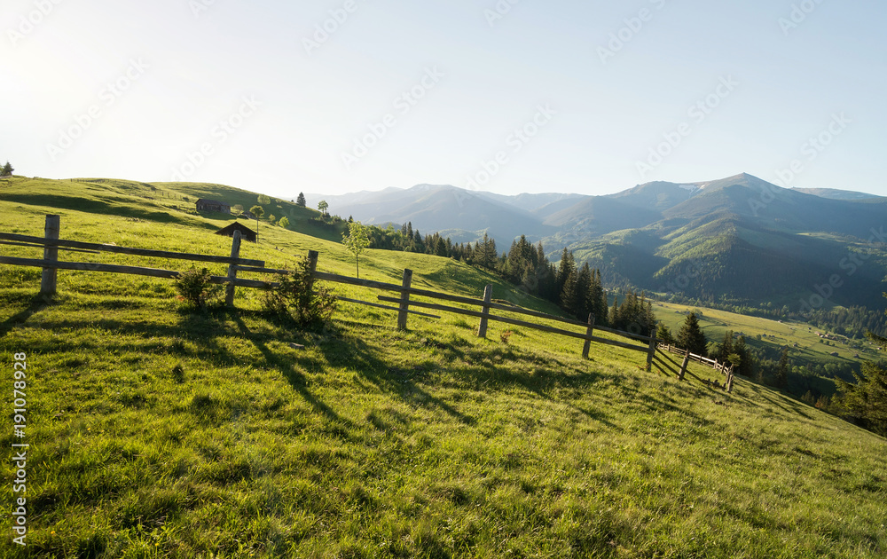 Fence on the mountain hills. Beautiful natural landscape in the summer time