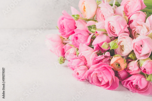 Ranunculus bouquet lying on a light table