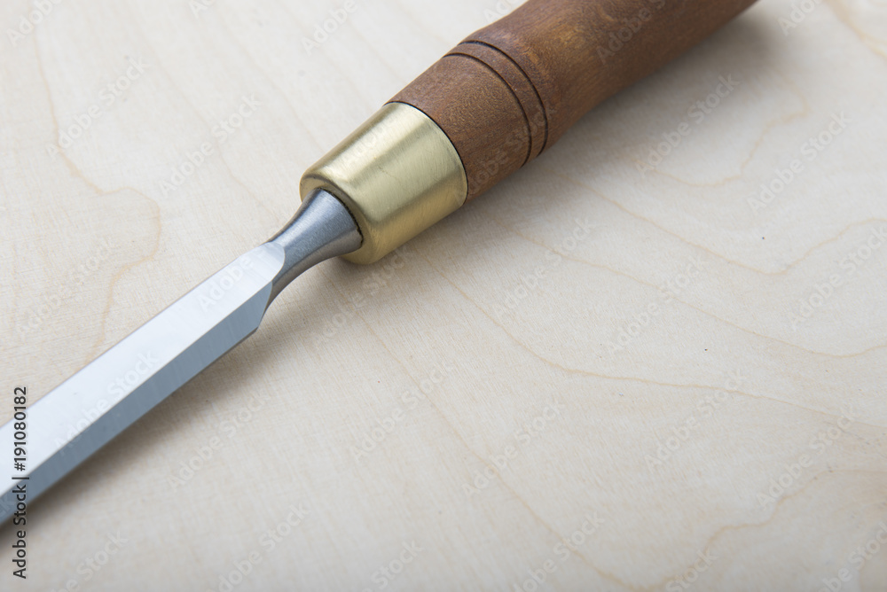 Fototapeta premium Professional chisels on a wooden background