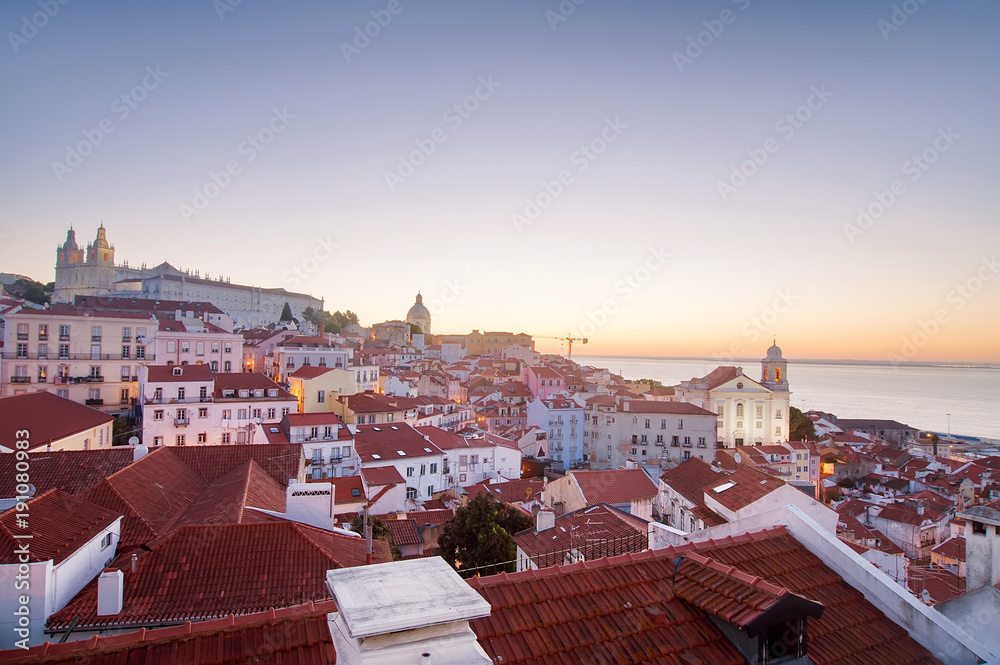 Panoramic view of the city on sunrise. red tiled roofs in Lisbon,  Portugal