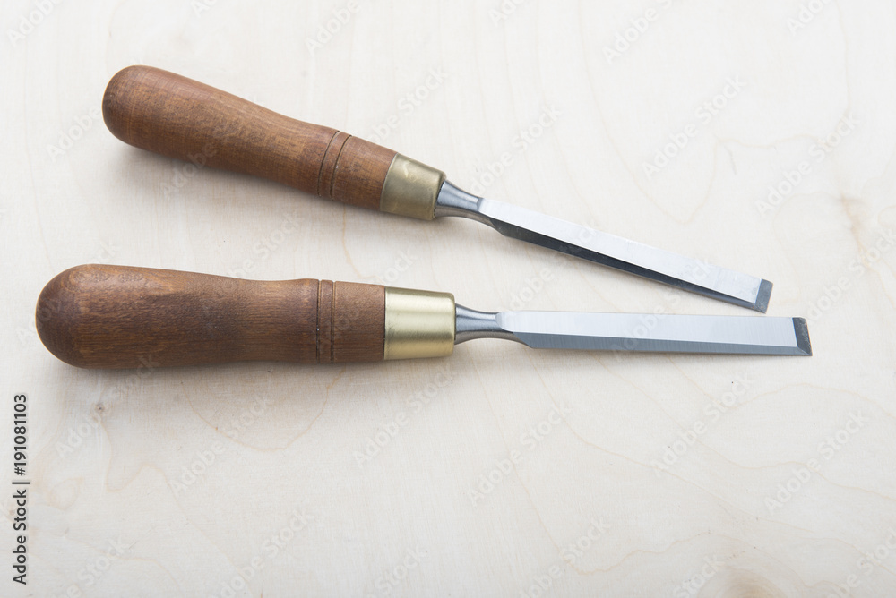 Professional chisels on a wooden background Professional chisels on a wooden background