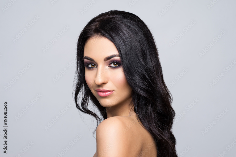 Beauty close-up portrait of beautiful, fresh and healthy woman. Human face over grey background Beauty close-up portrait of beautiful, fresh and healthy woman. Human face over grey background