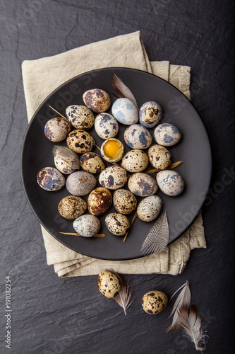 Quail eggs on dark background. Rustic style