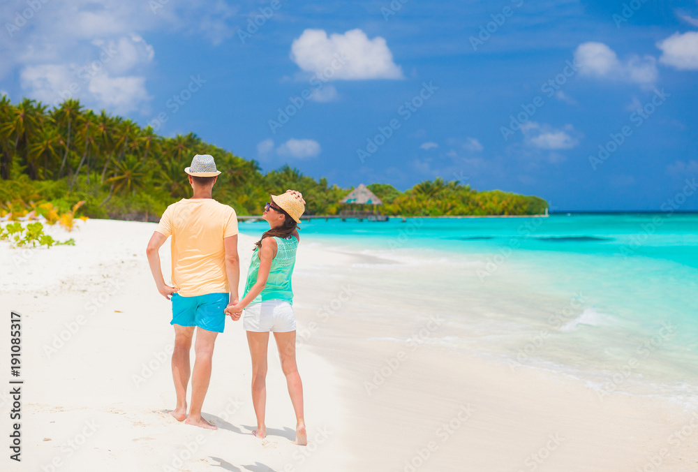 young happy family having fun on tropical beach. young happy family having fun on tropical beach.