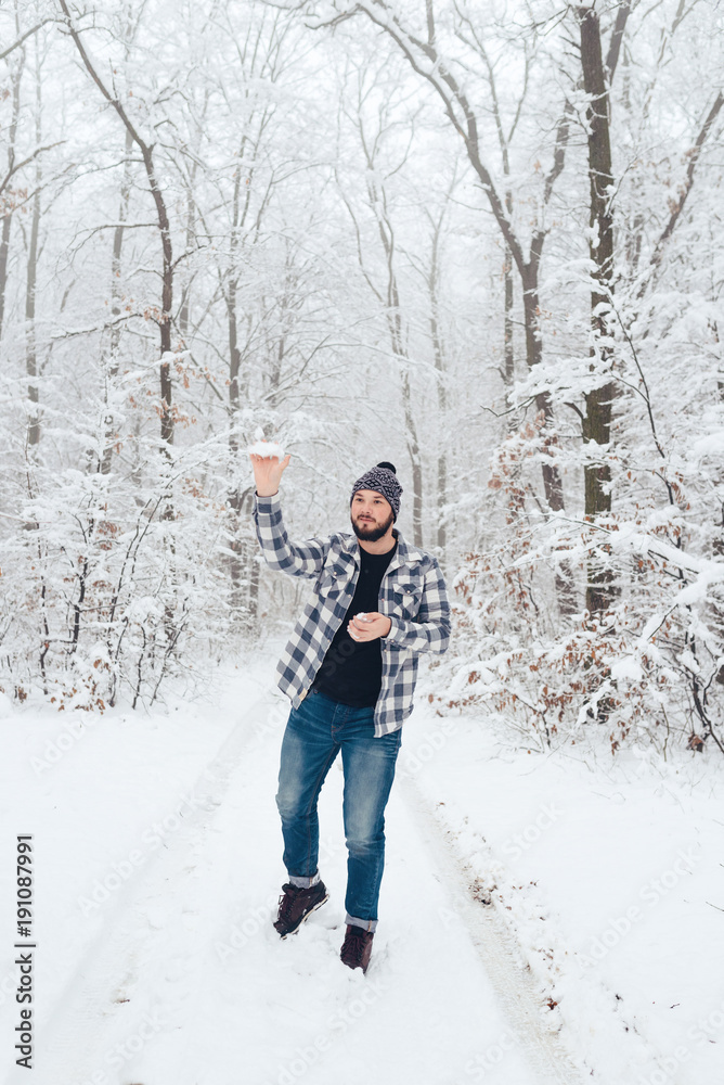 man in plaid shirt in the woods in winter