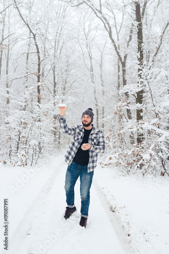 man in plaid shirt in the woods in winter