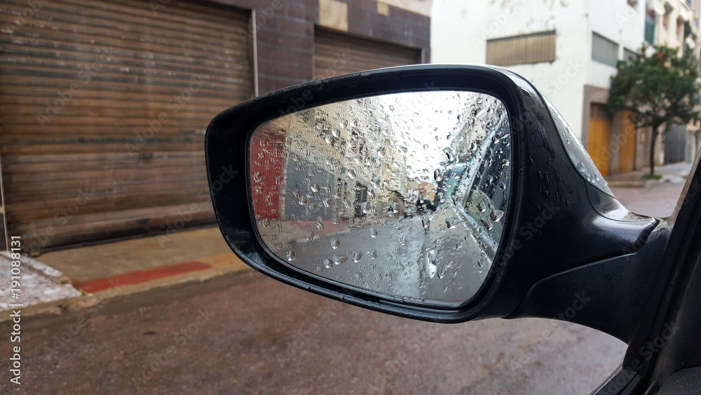 Rain on a car mirror. raindrops on car rear-view mirror