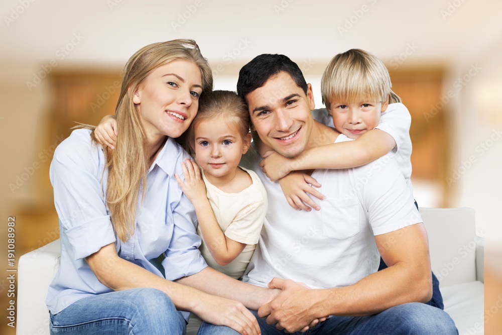 Beautiful smiling family sitting at sofa