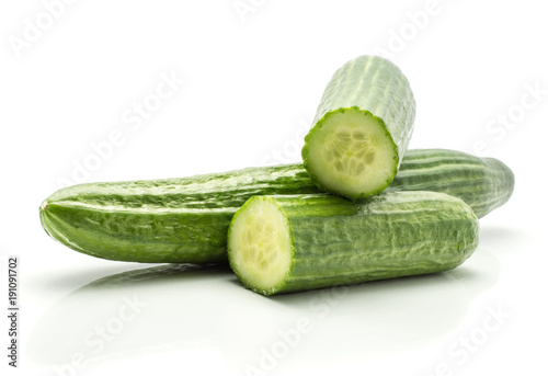 European cucumber (burpless, seedless, hothouse, gourmet, greenhouse or English) isolated on white background one whole and two fresh cut halves.