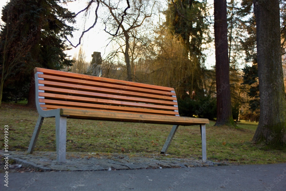 Bench for relaxation and meditation in the spring weather in the park.