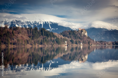 bled castle and mountains reflectiong in water, Slovenia photo