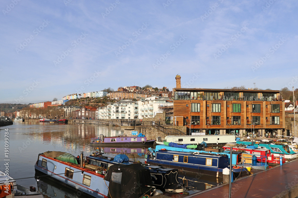 Harbourside scene featuring canal boats and modern apartments, Bristol, UK