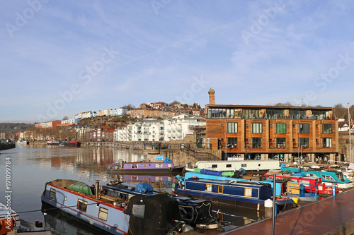 Harbourside scene featuring canal boats and modern apartments, Bristol, UK