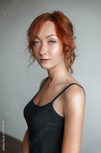 Redheaded girl in a black t-shirt in the Studio