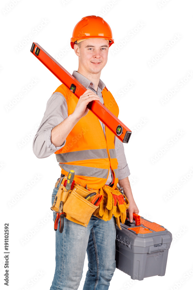 construction worker in a helmet with toolbox and looking at camera over white wall background. repair, construction, building, people and maintenance concept. construction worker in a helmet with toolbox and looking at camera over white wall background. repair, construction, building, people and maintenance concept.