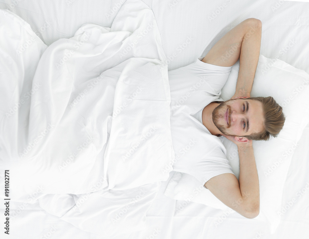 top view.smiling man relaxing on the couch top view.smiling man relaxing on the couch