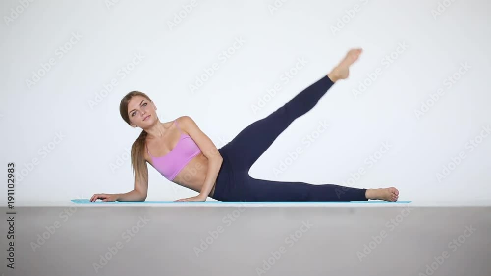 Young woman exercising on mat. Fitness and sports. Young woman exercising on mat. Fitness and sports.