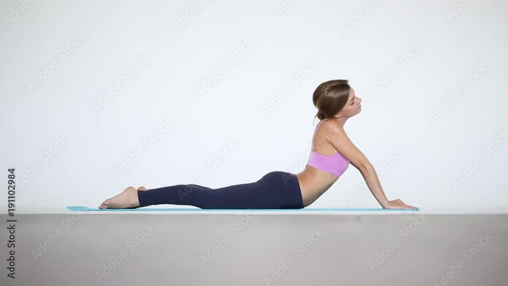 Young beautiful woman doing exercises on mat. Fitness and sports. Young beautiful woman doing exercises on mat. Fitness and sports.