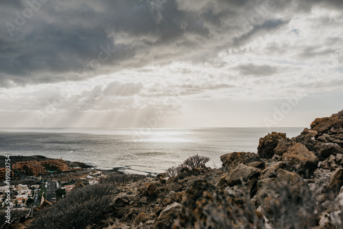 View of the town Palm Mar and the ocean with the rock on the front in the evening