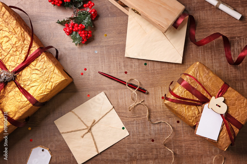 Composition with beautiful Christmas gift boxes on wooden background