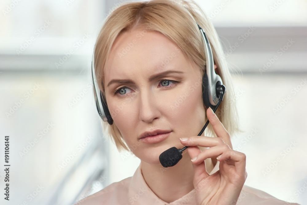 Portrait of sad call center operator. Blond mature woman with frown face dissapoint with something. Portrait of sad call center operator. Blond mature woman with frown face dissapoint with something.