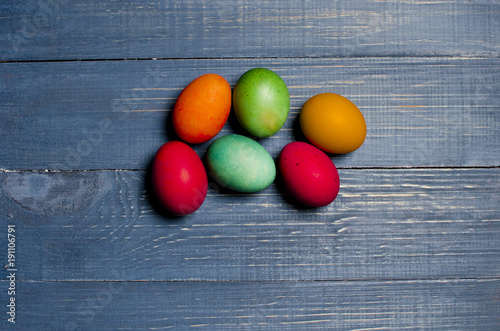 Painted chicken eggs for the traditional Christian holiday Easter on a wooden background painted blue.