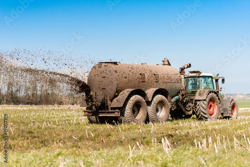 Tractor with manure tank on the field - 9092 photo