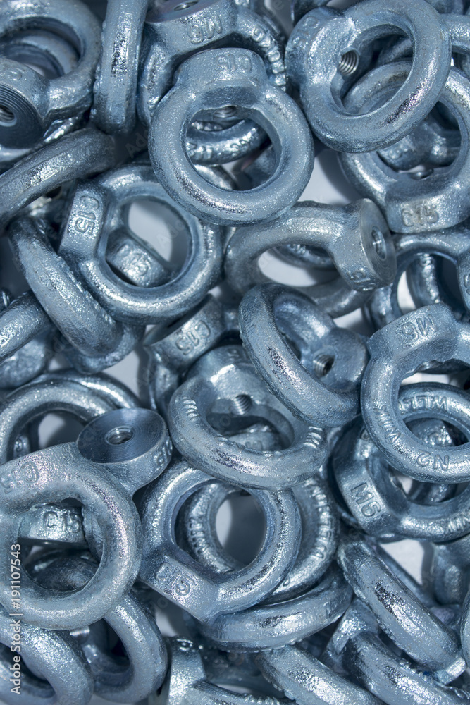 Lots of big industrial galvanized eye bolts on a pile