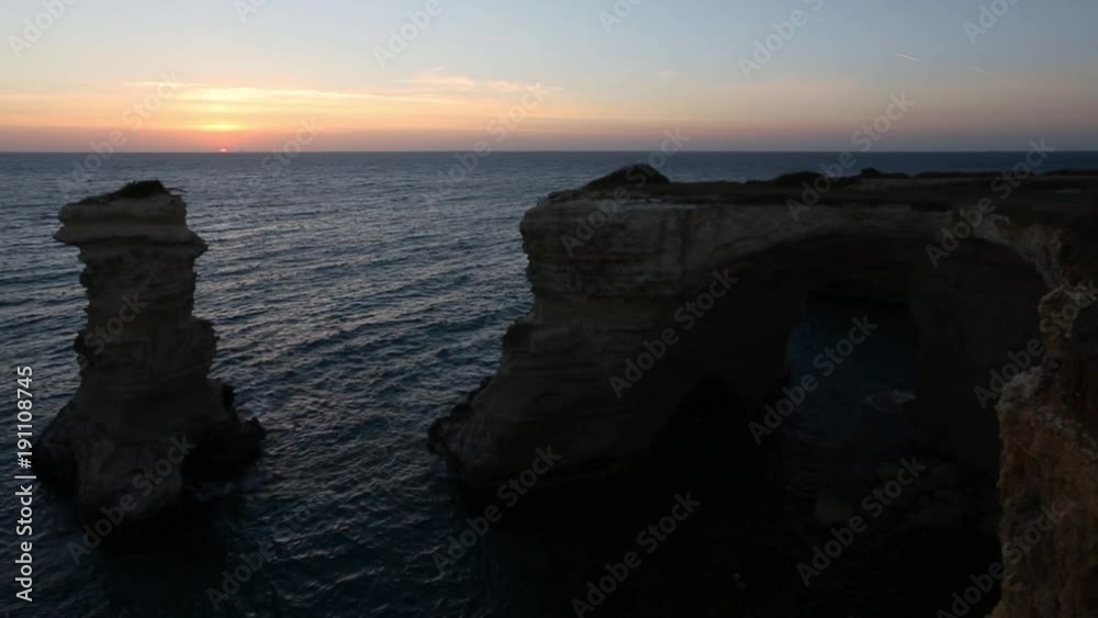 Sunset twilight seascape with cliffs, rocky arch and stacks (faraglioni), at Torre Sant Andrea, Salento Ionian sea coast, Puglia, Italy.
Sunset twilight seascape with cliffs, rocky arch and stacks (faraglioni), at Torre Sant Andrea, Salento Ionian sea coast, Puglia, Italy.