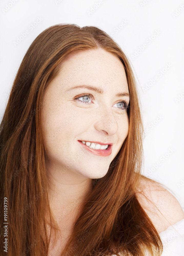 Beautiful young redhead woman with freckles portrait isolated on white Beautiful young redhead woman with freckles portrait isolated on white