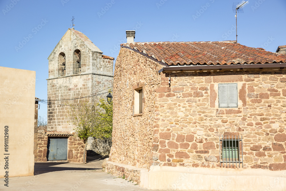 the church and a stone made house in Casillas (de Atienza), province of Guadalajara, Castile-La Mancha, Spain