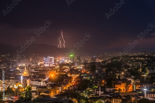 Beautiful lightning and heavy rain over the skyline of modern city at night