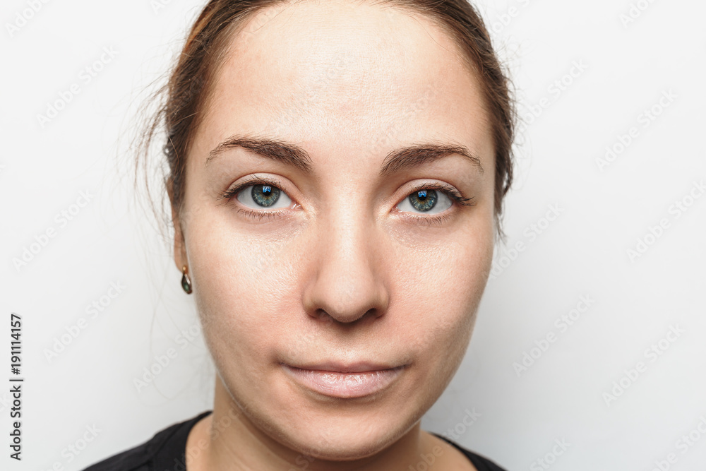 Portrait of a cute young girl without makeup looks at the camera Portrait of a cute young girl without makeup looks at the camera