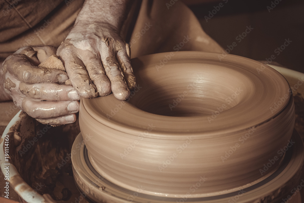 elderly man making pot using pottery wheel in studio elderly man making pot using pottery wheel in studio