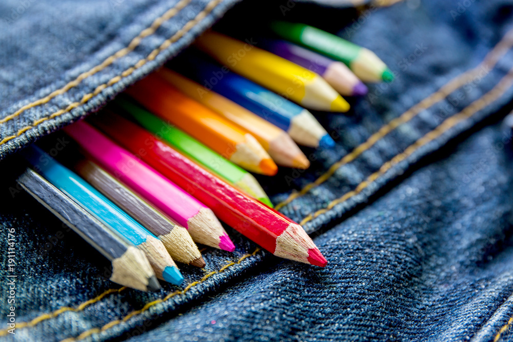 Multicolored pencils in the pocket of jeans Multicolored pencils in the pocket of jeans