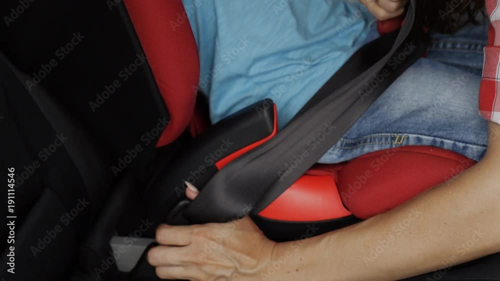 Positive mother fastens seat of infant car seat Positive mother fastens seat of infant car seat
