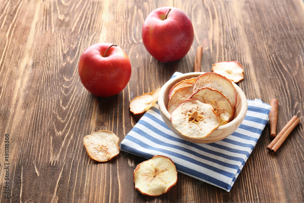 Composition with tasty apple chips on wooden background