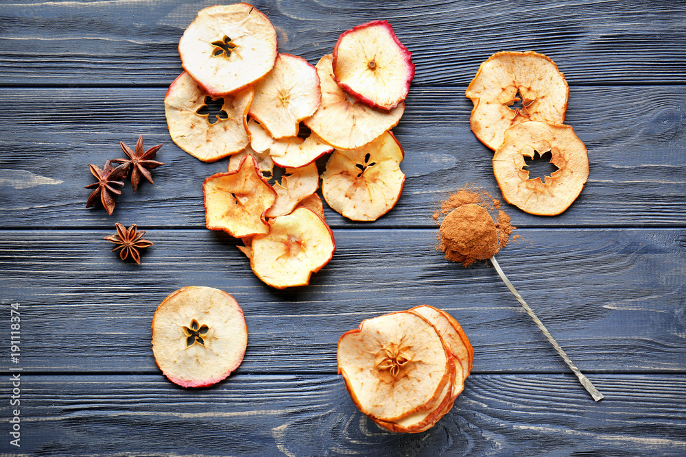 Fototapeta premium Composition with tasty apple chips on wooden background, top view