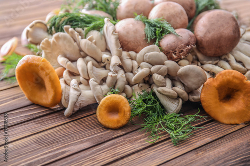 Variety of raw mushrooms on wooden table