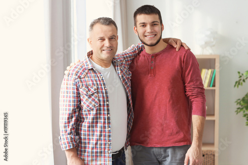 Mature man and his son at home