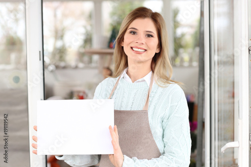 Business owner holding blank paper near her store, outdoors Free Download Business owner holding blank paper near her store, outdoors - GFXLoad