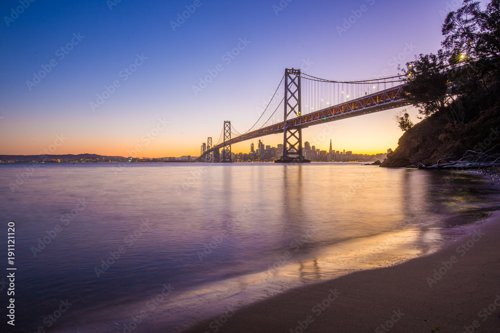 Obraz premium San Francisco skyline with Oakland Bay Bridge at sunset, California, USA