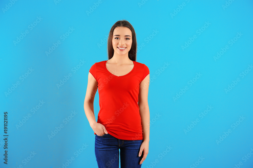 Beautiful young woman in red t-shirt on color background. Mockup for design