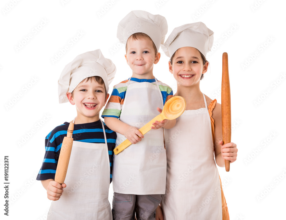Three young chefs standing together with ladle and rolling pin Three young chefs standing together with ladle and rolling pin
