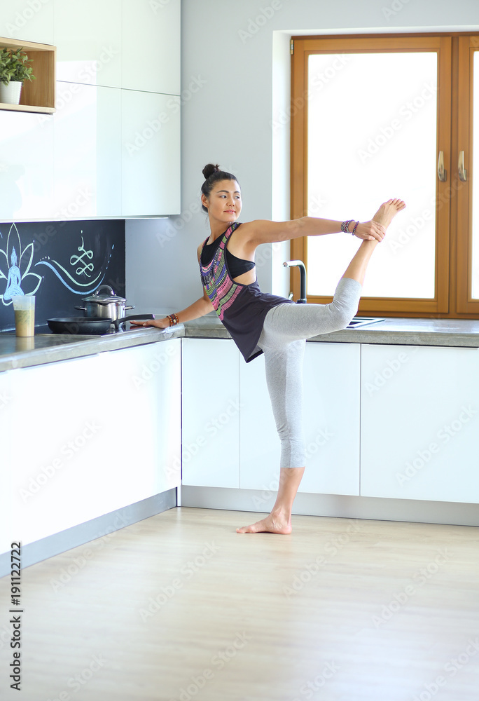 Fitness girl cooking healthy food in the kitchen. Woman. Kitchen. Cooking Fitness girl cooking healthy food in the kitchen. Woman. Kitchen. Cooking