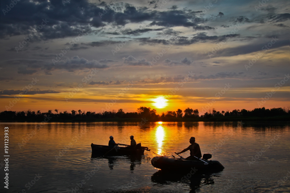 Fishermen at sunset return