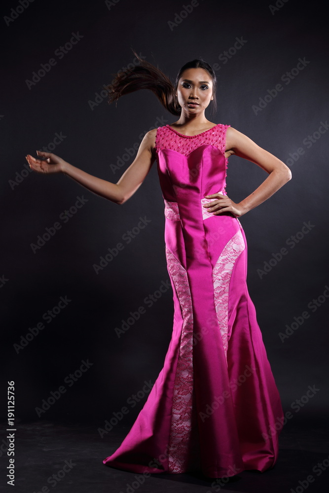 Fototapeta premium Asian woman in evening long ball dress