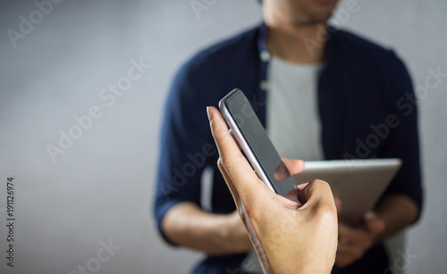 Man using phone over other studying