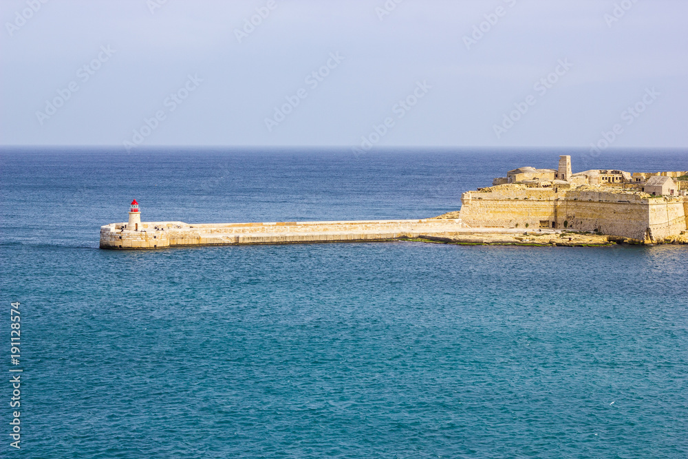 Malta coastline with stunning turquoise water around the light house