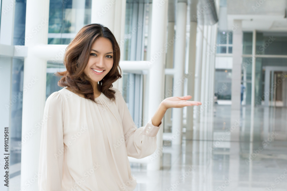 business woman pointing sideway to blank space, office building rental space offer concept business woman pointing sideway to blank space, office building rental space offer concept